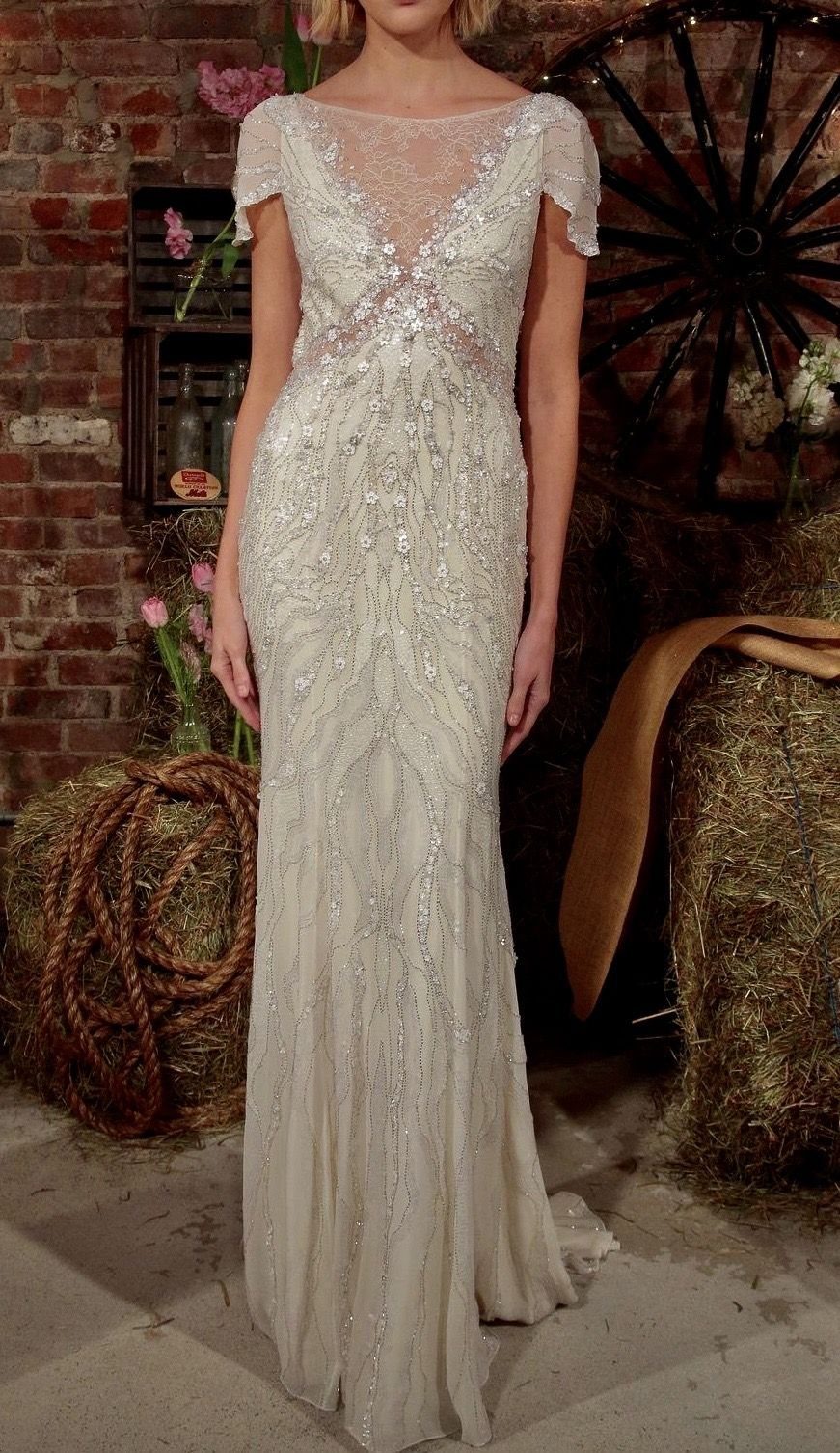 Art Deco Wedding Dress: 11 Styles From Beaded Trains to Choker Accents 7 Woman wearing a beaded white wedding dress with delicate cap sleeves in a rustic setting.