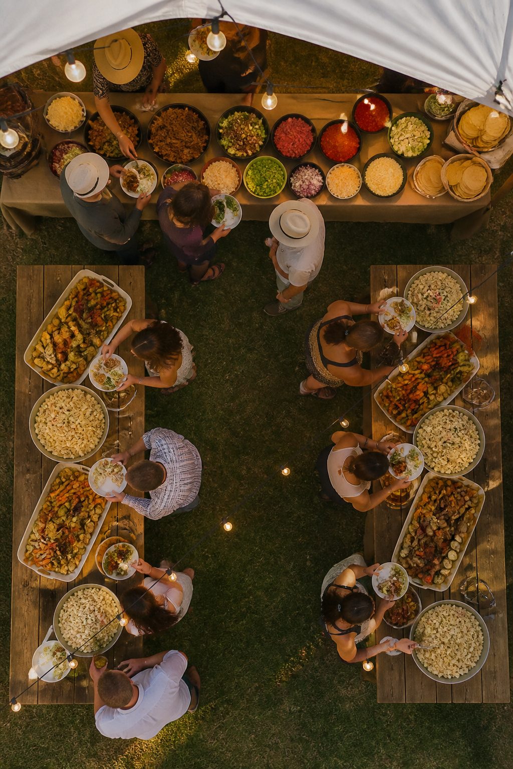 Taco bar with various toppings and ingredients for a wedding.