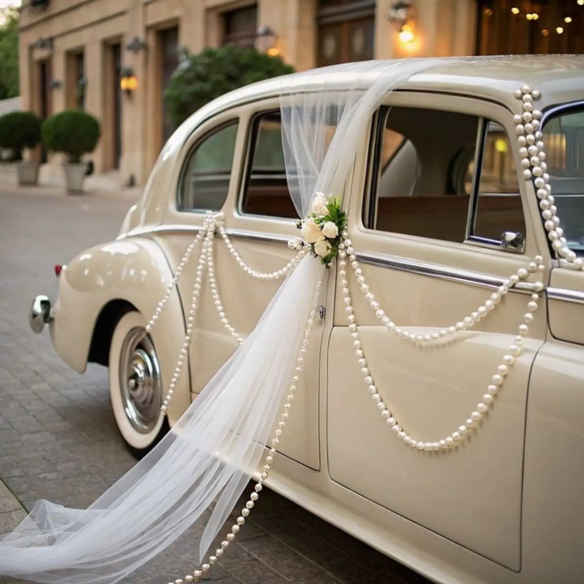Shabby Chic Wedding: 10 Ideas for Timeworn Charm 1 A cream vintage wedding car decorated with white pearl strands and a floral tulle veil.