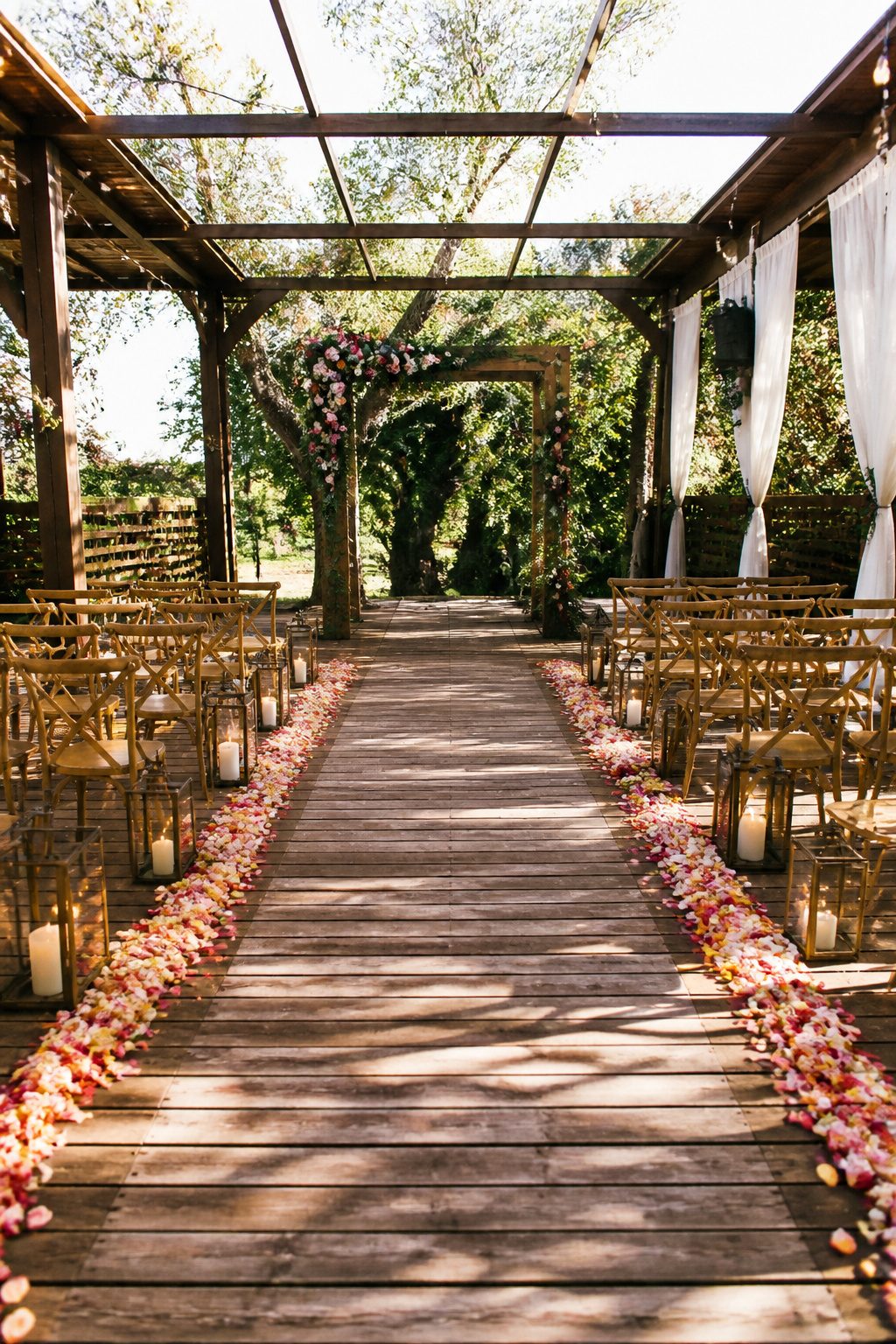 9 Wedding Ceremony Decoration Ideas: From Arch to Exit 2 Aisle with flower petals and lanterns guiding to the ceremony arch.