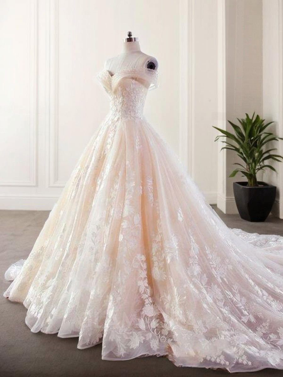 Wedding Dress White and Pink: 8 Gowns for a Colorful Ceremony 1 A sleeveless A-line wedding gown with white floral lace over a pink tulle skirt.