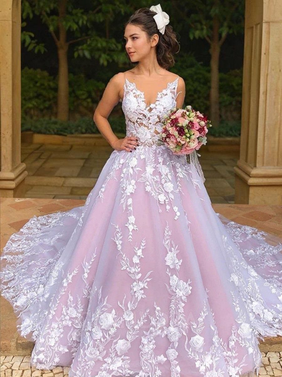 Wedding Dress White and Pink: 8 Gowns for a Colorful Ceremony 5 Woman wearing a white lace bodice wedding dress with a pink tulle A-line skirt.