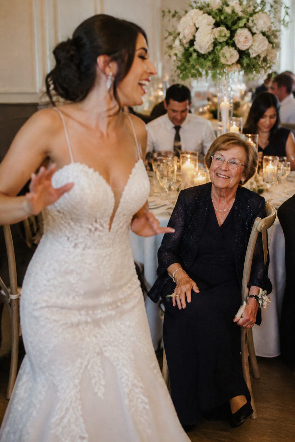 Bride laughing with her grandmother during the wedding reception.
