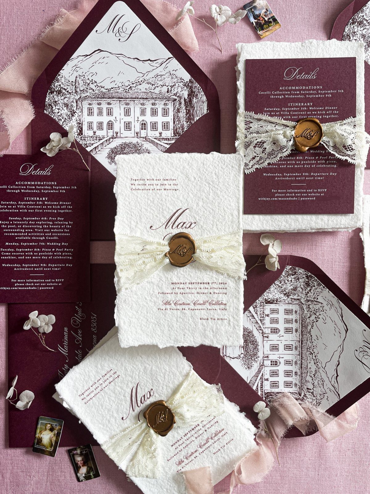 Wedding Invitations with Ribbon: 5 Ideas That Look Handmade 4 Wedding invitations with burgundy envelopes, white textured cards, lace ribbons, and gold wax seals on pink fabric.