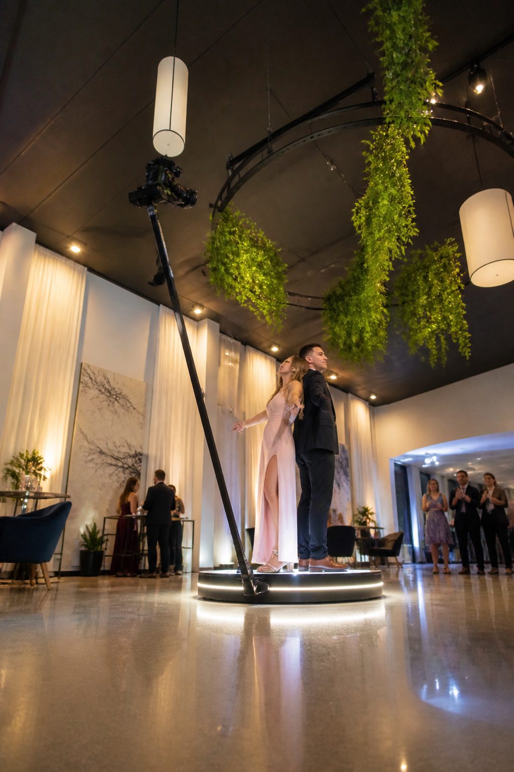 A 360-degree photo booth with a rotating camera and platform.