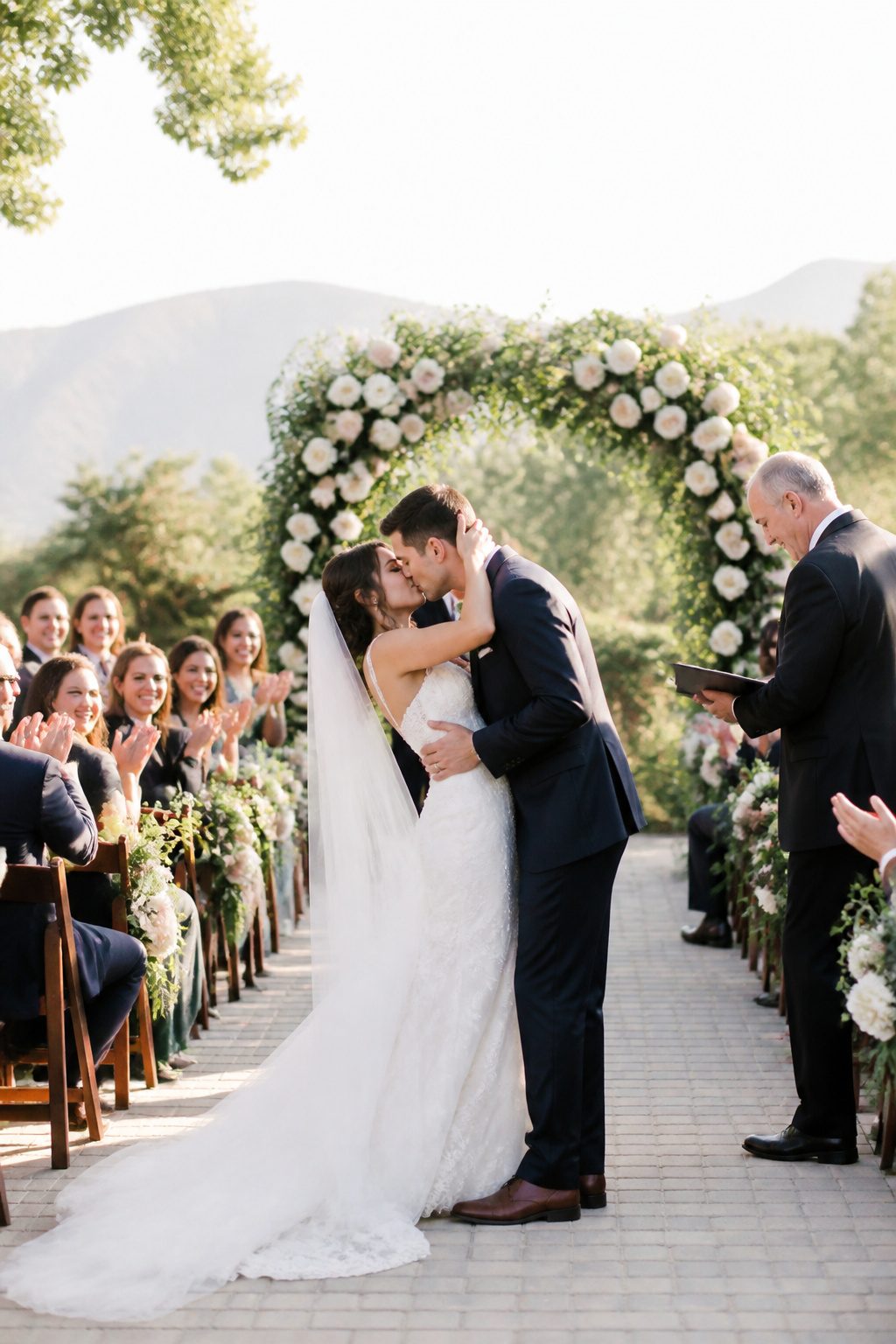 20 Wedding Photos Ideas for 2026 18 Couple sharing their first kiss during the ceremony.